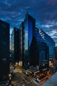 a group of tall buildings in a city at night at Insadong Crown Hotel in Seoul
