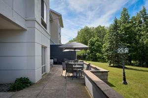 a patio with a table and an umbrella at Fairfield Inn & Suites Cleveland Avon in Avon