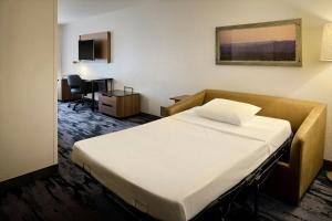 a hotel room with a bed and a desk at Fairfield Inn & Suites Cleveland Avon in Avon