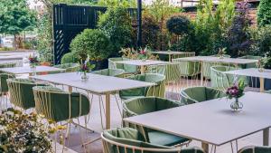 a row of tables and chairs in a garden at Hotel Fénix, a Gran Meliá Hotel - The Leading Hotels of the World in Madrid