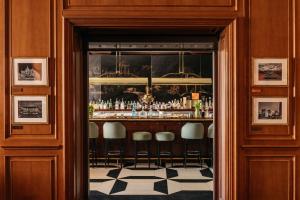 a bar in a building with stools in a doorway at Hotel Fénix, a Gran Meliá Hotel - The Leading Hotels of the World in Madrid +76 photos