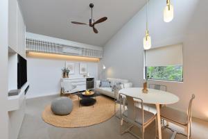 a living room with a table and a couch at Tree Villa Bangkok in Bangkok