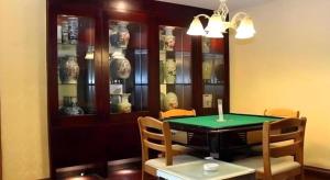 a dining room with a table and some vases at Juntong Hotel in Bao'an
