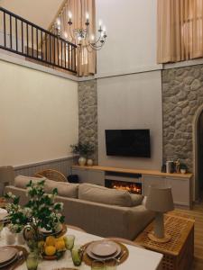 a living room with a couch and a fireplace at Oxygen Cloud Khaoyai Managed by OHS in Ban Bung Toei