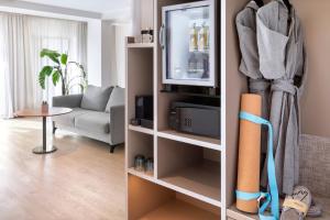 a living room with a tv and a couch at INNSiDE by Meliá Zaragoza in Zaragoza