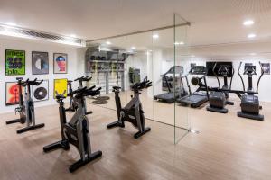 a gym with treadmills and elliptical machines at INNSiDE by Meliá Zaragoza in Zaragoza
