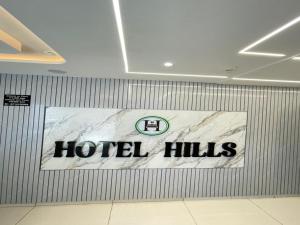 a sign on the wall of a hotel lobby at Hotel hills in Ahmedabad