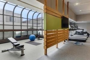 a gym with tread machines and a large window at Courtyard by Marriott Pittsburgh Airport in Coraopolis