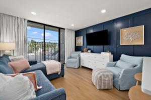 a living room with blue walls and a tv at Ocean Side Beach Condo in Ocean City