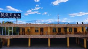 a hotel with a sign in front of it at Hostal Mariscal Sucre in Tababela