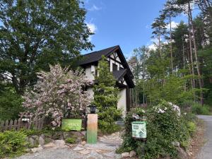 a small house with a sign in front of it at Villa Grace in Hokuto