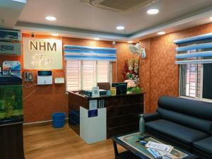 a waiting room at a nimini store with a fish tank at NHM Stays in Garui