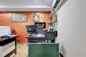 an office with a desk with a computer on it at Hotel O Satyam Junction Seethammadhara in Visakhapatnam
