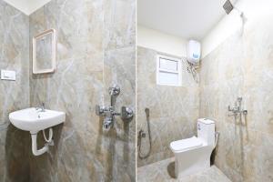 a bathroom with a toilet and a sink at Hotel O Satyam Junction Seethammadhara in Visakhapatnam