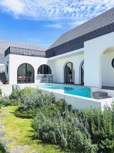 a villa with a swimming pool and a house at Oxygen Cloud Khaoyai Managed by OHS in Ban Bung Toei