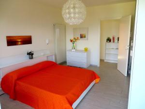 a bedroom with a red bed and a chandelier at Africa in Stresa