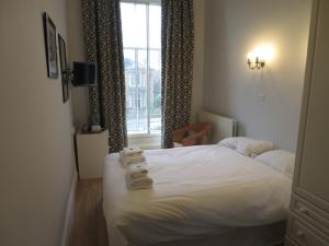 a bedroom with a bed and a window at Thornfield Guest Residence in Edinburgh