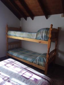 two bunk beds in a room with a bed at Cabañas moye in Santa Rosa de Calamuchita