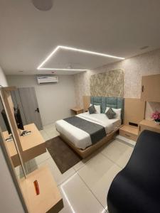 a bedroom with a bed and a chair in it at Hotel hills in Ahmedabad