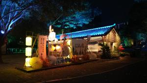 a man standing on top of a house at night at Castfast Hotel in Dongguan +114 photos