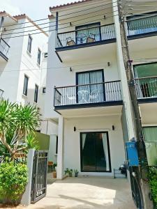 a white building with balconies on it at Sunday House - Fisherman Village Samui in Bophut