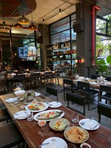 a table with plates of food on it in a restaurant at Sibtis Hotel in Lampang