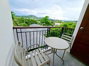 a balcony with a table and chairs and a view at Sunday House - Fisherman Village Samui in Bophut