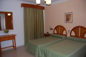 Postel nebo postele na pokoji v ubytování Hotel Antonio Conil