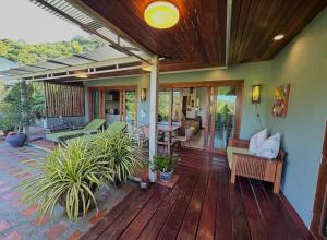 a porch with a wooden deck with plants at keio place in Thong Nai Pan Yai