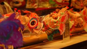 a close up of a toy dragon on a table at Castfast Hotel in Dongguan