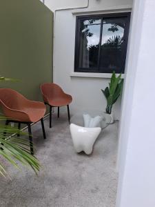 a room with two chairs and a table and a window at Sunday House - Fisherman Village Samui in Bophut