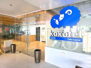 a store with a blue sheep sign on a glass wall at Kokotel Cebu Capitol in Cebu City