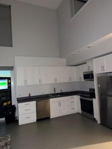 an empty kitchen with white cabinets and appliances at Moonlit Serenity 2 in Oakland