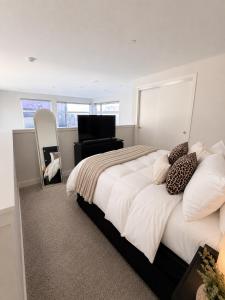 a bedroom with a bed with a mirror and a chair at Moonlit Serenity 2 in Oakland