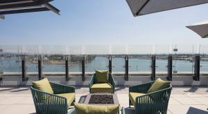 a patio with chairs and a view of the water at Moonlit Serenity 2 in Oakland