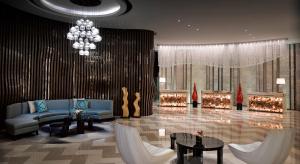a living room with a blue couch and a chandelier at Meliá Jinan in Jinan
