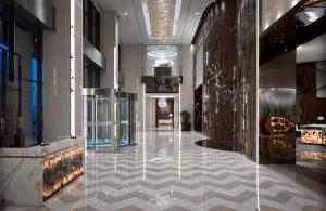 a lobby of a building with a checkerboard floor at Meliá Jinan in Jinan