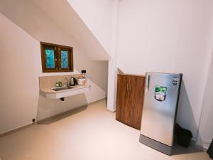 a kitchen with a refrigerator and a sink at Lavera hideout in Dickwella