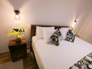 a bedroom with a bed with white sheets and pillows at Lavera hideout in Dickwella
