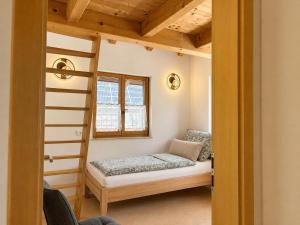 a bedroom with a bunk bed and a window at NaturZeit Melleck in Schneizlreuth