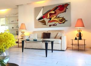 a living room with a couch and a table at Les Remparts Antibes Location in Antibes