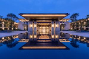 a villa with a swimming pool at night at Gran Meliá Chengdu in Chengdu