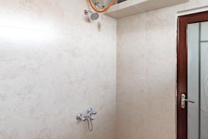 a bathroom with a shower with a shower head at Urbanview Syariah Hotel Kanigara Batu in Batu +44 photos