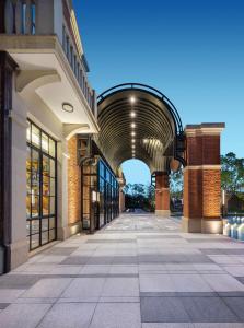 a building with an archway in the middle of a street at Meliá Shanghai Parkside in Shanghai