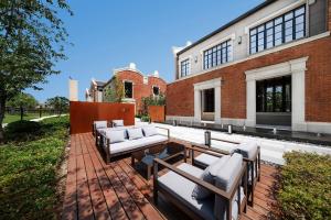 a patio with couches and tables in front of a building at Meliá Shanghai Parkside in Shanghai