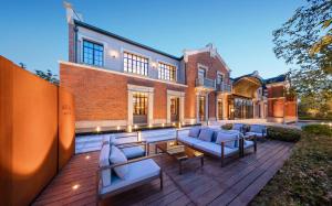 an outdoor patio with couches and tables on a building at Meliá Shanghai Parkside in Shanghai +47 photos