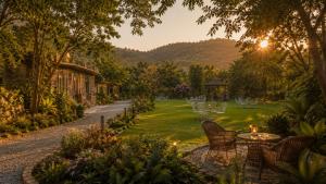 a garden with a table and chairs and a lawn at Sariska Forest Trail in Rāmsinghpura