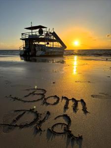 words written in the sand on a beach at sunset at Catamara Fenda do Biquini in Cabedelo