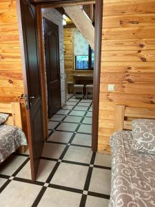 a room with a door leading to a room with a table at Cottages on Polyova in Zgorany