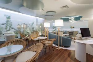 a restaurant with tables and chairs and a counter at Meliá Lisboa Oriente in Lisbon +35 photos